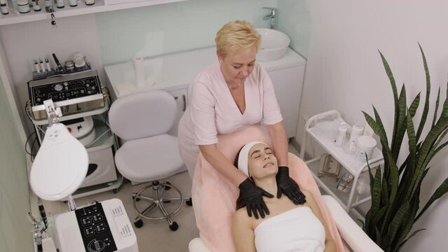 Treatment procedure, Calming products, Nourishing cream. Face cream with soothing properties is applied by cosmetologist, who rubs it into skin before finishing treatment with mask.