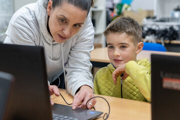 Robotics teacher teaching programming to a child