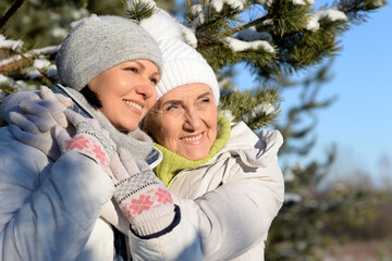 Happy women in winter clothes posing outdoors