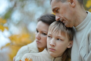 Obraz premium Portrait of a family of three on the nature