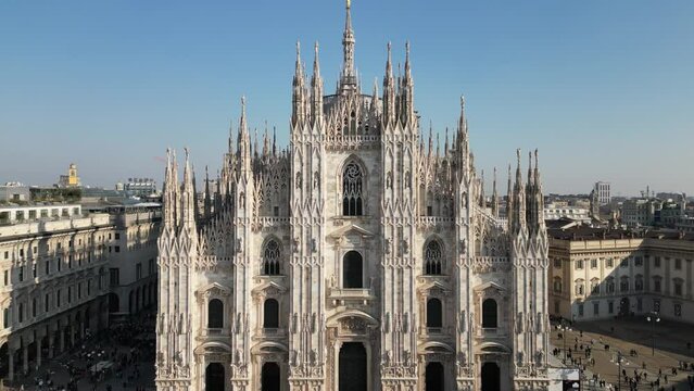 Aerial drone view of Piazza del Duomo in Milan with crowd near old buildings and Metropolitan Cathedral-Basilica of Nativity of Saint Mary in Italy in daylight