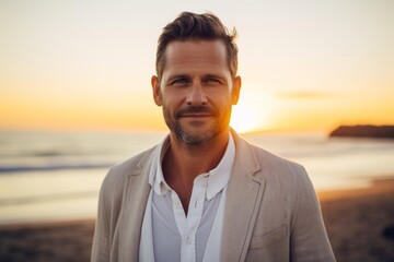 Fototapeta premium Portrait of a content man in his 40s wearing a chic cardigan against a beautiful beach sunset. AI Generation