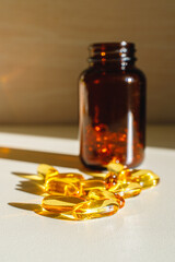 Omega 3 capsules on the table. Bottle of fish oil.