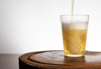 Pouring light beer on typical brazilian cup (americano long drink).