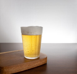 Glass of light beer on typical brazilian cup (americano long drink).