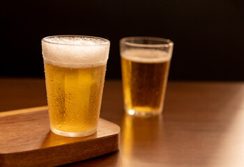 American glass with Beer on wooden table (Traditional Brazilian Cup)