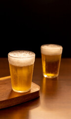 American glass with Beer on wooden table (Traditional Brazilian Cup)