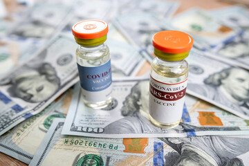 coronavirus vaccine or other in bottle on dollar paper background