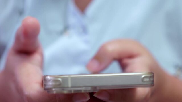 Close-up of an individual browsing the internet and updating social media using a mobile phone.
