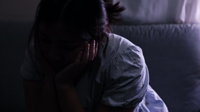 Scratching her head in desperation, a woman is filled with anxiety and showing signs of stress and depression.