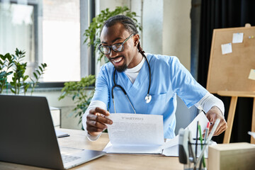 handsome jolly african american doctor holding his notes during online consultation, telehealth