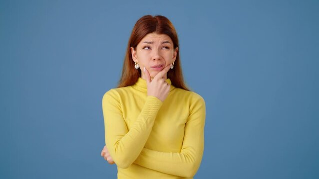 Thoughtful young woman refuses bad ideas on blue background