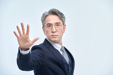 A middle-aged man in a suit expresses various emotions through facial expressions and hand gestures.