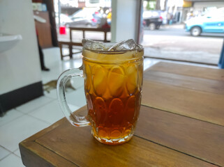 Selective focus of sweet iced tea on a wooden table