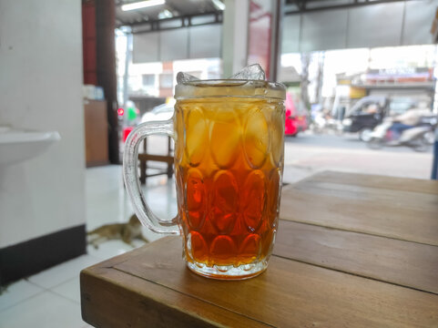 Selective focus of sweet iced tea on a wooden table