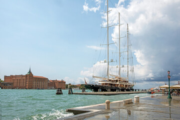 Fototapeta na wymiar pleasure boat with three matches is berthed in Venice. rest and travel