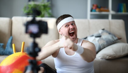 Screaming Vlogger Recording Boxing Video on Camera. Bearded Man Shooting Workout on Digital...