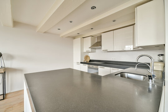 Modern kitchen interior with white cabinets and granite countertop