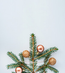 Christmas background with spruce branch and Christmas tree balls with glitter.