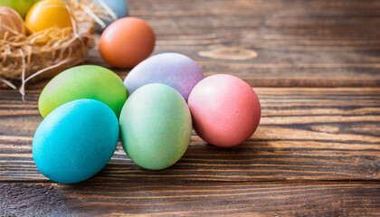 Colorful painted Easter eggs on wooden background, copy space