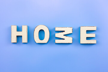 The word Home from wooden letters on a blue background.