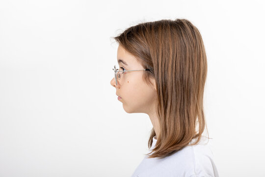 Side view portrait of girl with glasses, isolated on white background.