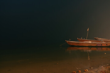 Boats on the pre-dawn sacred river Ganges in Varanasi, India