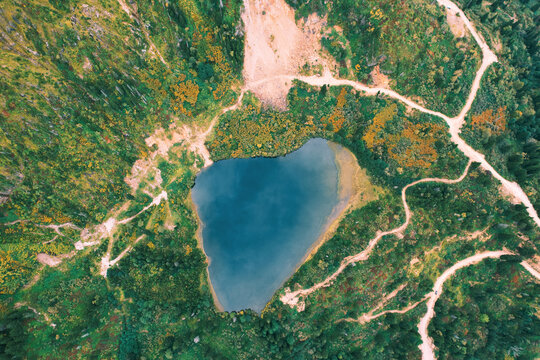 Heart shaped lake in mountains. Aerial top view, drone photo