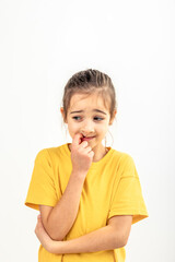 Scared and anxious girl, biting her fingernails on a white background isolated.