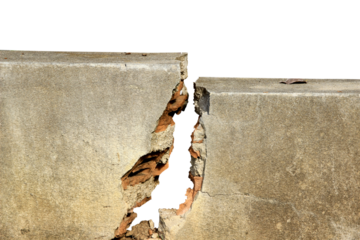 The old cement wall is broken, cracked, and damaged isolated on white background.