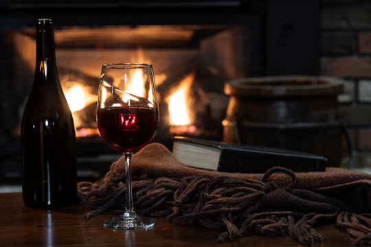 Glass of wine with fireplace in background