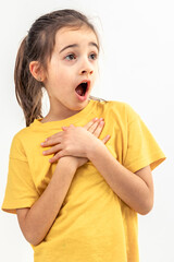 Little girl looks to the side in surprise on a white background isolated.
