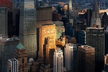 New York City aerial view of Midtown Manhattan with spotlight effect of sun rays illuminating...