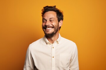 Fototapeta premium Portrait of a joyful man in his 30s wearing a cozy sweater against a soft orange background. AI Generation