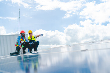 Engineer technician using laptop checking and operating system on rooftop of solar cell farm power...