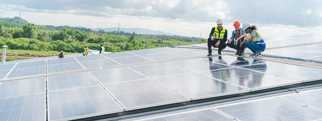 Male engineering teams install solar panels at solar power generating station, Professional...