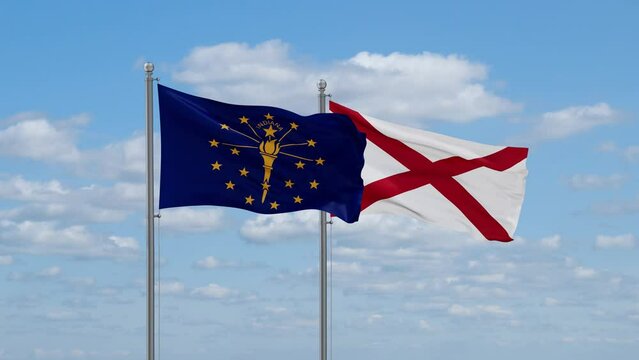 Alabama and Indiana US state flags waving together on cloudy sky, endless seamless loop