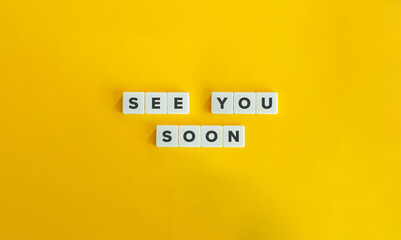 See You Soon Phrase on Block Letter Tiles on Yellow Background. Minimalist Aesthetics.