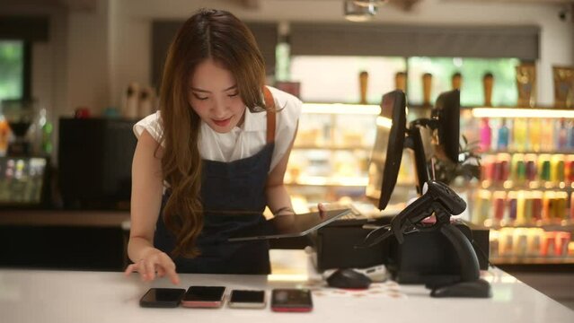 An Asian young Cashier woman working in  supermarket