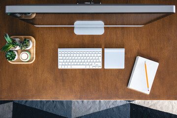 Top view, computer on a wooden table, work desk.