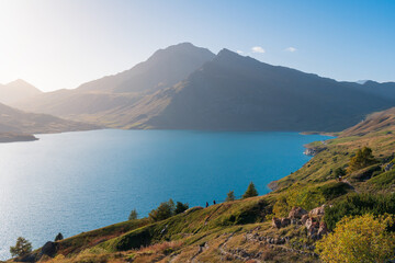 Mont-Cenis (Moncenisio) lake and mountain peak (Val-Cenis), blue sky, soft light, shore and clear...