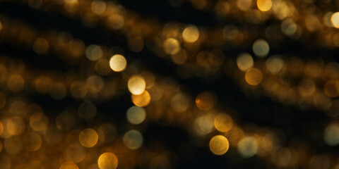Abstract background of blurred yellow lights for design. Lights bokeh dis focus. Christmas background, copy space. Web banner