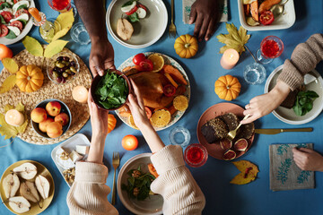 Group of people sharing delicious meals at traditional thanksgiving feast