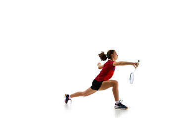Fototapeta na wymiar Dynamic portrait capturing athleticism of young, attractive female badminton player in motion during training against pristine white background. Concept of sport, strength and power, action.