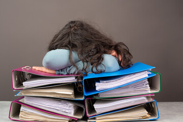 Exhausted tired woman sleeping on a pile of file folders, burnout, stress and overworked, pressure...