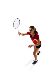 Dynamic movements of professional badminton player practicing with intensity against pristine white background. Concept of sport, active lifestyle, strength and power, action. Copy space.