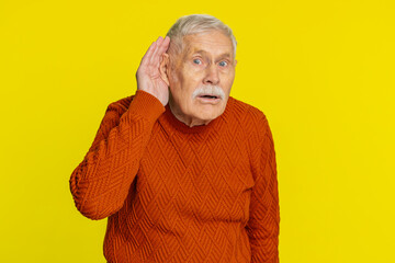 I can't hear you. What. Senior old man trying hear you, looking confused and frowning keeping arm...
