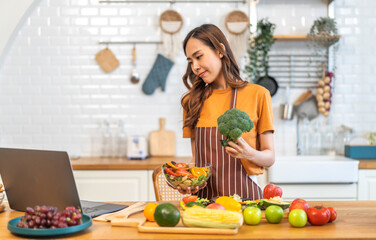 Portrait happy beauty slim healthy asian woman and vegan food healthy fresh vegetable and fruit in kitchen.diet, vegetarian, eating, fruit, wellness, health, green food.Fitness, healthy food