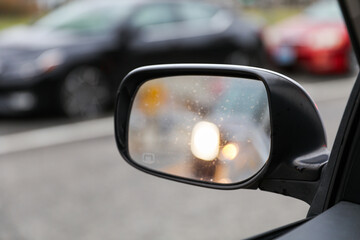 reflection in car mirror, conveying introspection and perspective in a fleeting moment of travel