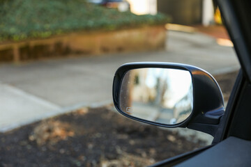 reflection in car mirror, conveying introspection and perspective in a fleeting moment of travel